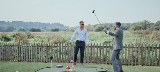 Two people playing mini golf at Sopley Mill.